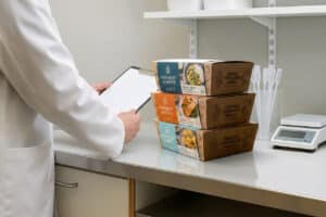 Food packaging being checked for GIO compliance and printing ink safety in laboratory environment